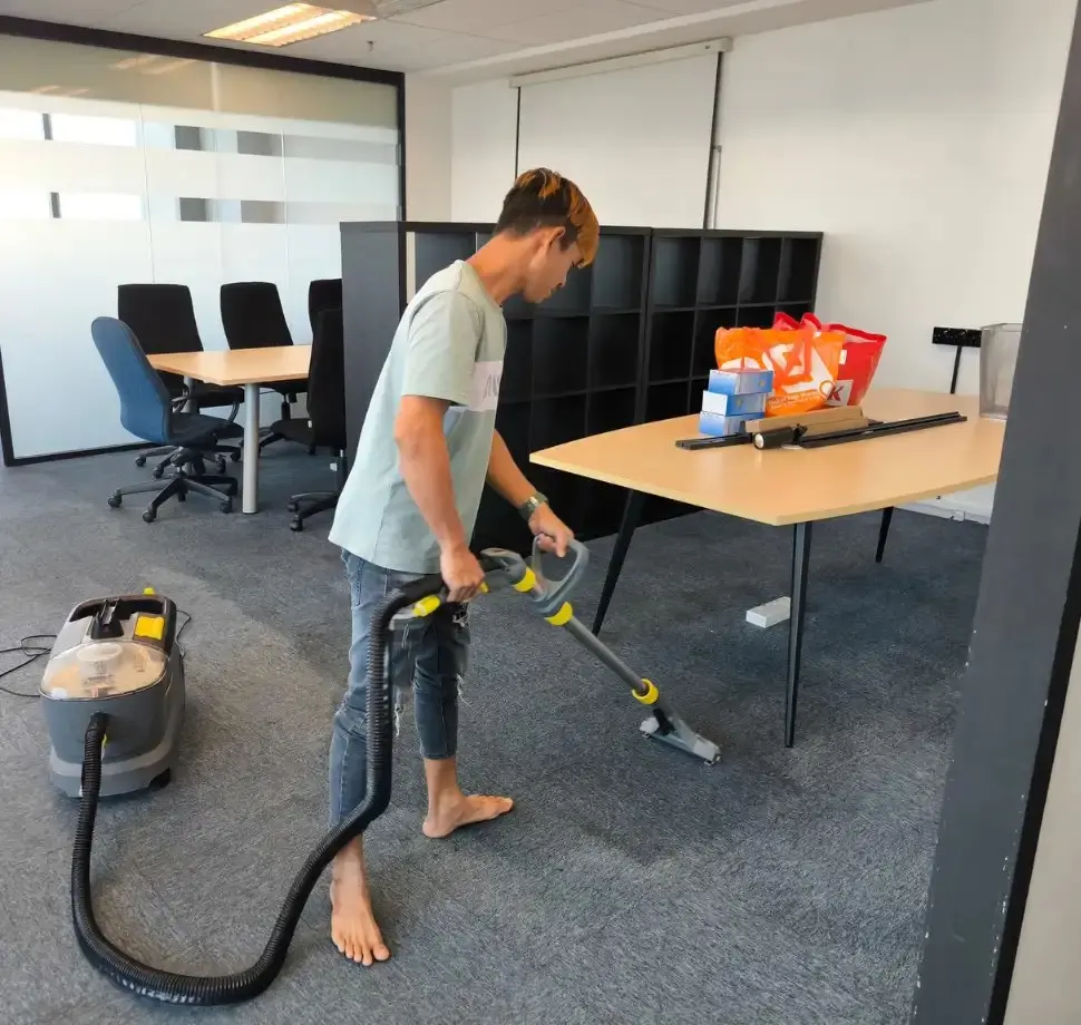 Antz cleaner using carpet extraction equipment in an office